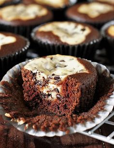 chocolate cupcakes with white frosting on a cooling rack