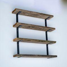 a shelf made out of wooden planks with metal brackets on the bottom and sides