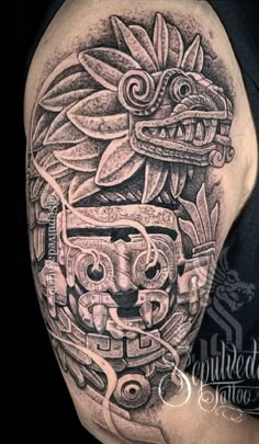 a man's arm with tattoos on it and an image of a totema