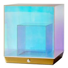 a glass box with a metal handle on the bottom and blue back ground, in front of a white background