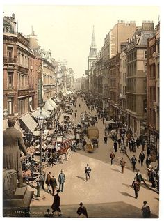 an old photo of people walking down the street