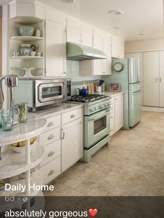 a kitchen with white cabinets and green appliances