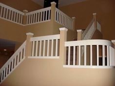 there are two balconies on top of the stairs in this house that is painted tan and white