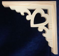 a wooden shelf with a heart cut out of it's sides on a blue background