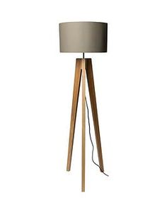 a wooden floor lamp with a white shade