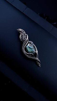 This cute pendant is woven of german silver. In the center of the jewelry is a cabochon of a labradorite stone. The stone sparkles very beautifully under the rays of light.  The pendant is made entirely by hand using the wire wrap technique. All curls are securely fixed, artificially darkened and polished to a mirror finish. Chain included. Select the chain length from the menu ATTENTION: Please note that In reality colors of jewelry may look slightly different than colors in photos on your screen. It depends on your monitor calibration and its color rendering. HOW TO CARE: Over time, the metal may darken slightly. It depends on the degree of contamination of the surface of the jewelry. It is very easy to clean metal with cloths for jewelry. Or rub thoroughly with a toothbrush with toothpa Wire Wrap