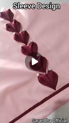 an image of a bed with pink sheets and red flowers on the bottom half of it