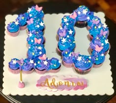 a birthday cake with the number 30 decorated in blue icing and stars on it