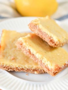 three pieces of cake on a plate with lemons in the background