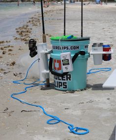 the buckets are sitting on the beach by the water