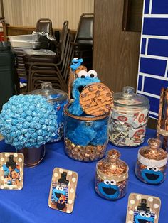 the cookie monster table is set up with candy and candies