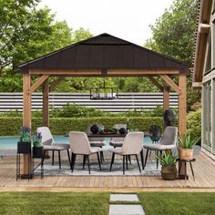 a wooden gazebo sitting next to a pool with chairs and tables on top of it