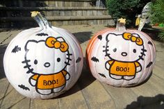 two pumpkins decorated with hello kitty designs