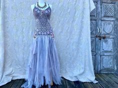 a mannequin is dressed in a dress with an elaborate beaded neckline