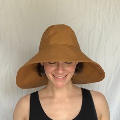 "Say hello to the sun hat of your dreams!  The oversized brim - made from a beautifully neutral Carhartt Brown canvas - protects your face and neck from the sun.  The inner crown is lined with the lightest, softest SWEAT WICKING technical fabric.  This hat is fully foldable, packable, mushable--take it anywhere! Specifications:  100% Cotton Canvas Outer  Polyester Moisture Wicking Liner Nylon Cordura Interfacing Measurements: Size Small head size 22\" (56 cm) Size Medium head size 23\" (58 cm) Size Large  head size 24\" (61 cm)" Wide Brim Travel Sun Hat, Solid Color Curved Brim Hats For Warm Weather, Adjustable Sun Hat With Uv Protection For Everyday, One Size Fits Most Sun Hats For Warm Weather, Warm Weather Sun Hats One Size, Uv Protection Hats One Size Fits Most For Everyday, Lightweight Curved Brim Sun Hat, One Size, Uv Protection Hat For Everyday, Everyday Lightweight Brimmed Sun Hat