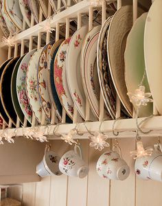 a bunch of plates are hanging on a rack