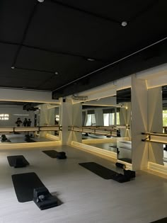 an empty gym with mirrors and yoga mats