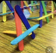 colorful popsicle sculptures sitting on top of a wooden table