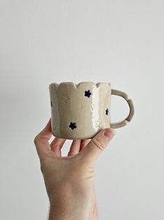 a hand holding a coffee cup with stars on it