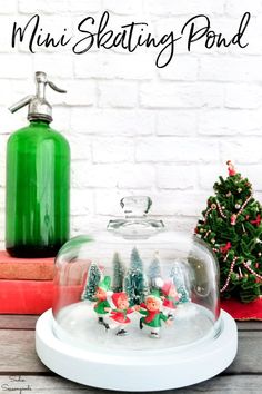 christmas scene with an upcyled cheese dome and miniature trees under glass on wooden table