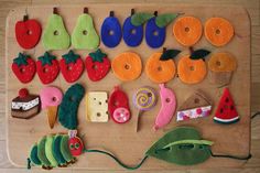 a wooden board with felt food on it