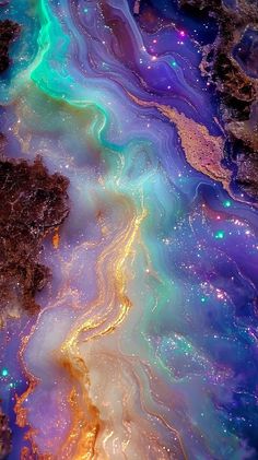 an aerial view of the earth's surface with colorful liquid pouring out of it