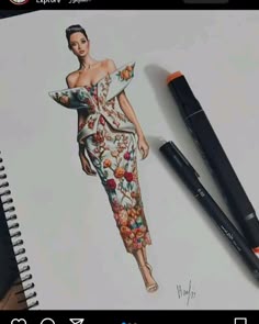 a drawing of a woman in a floral dress with an orange marker next to it