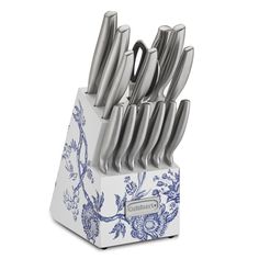 the blue and white knife holder is holding many knives