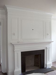 an empty living room with a fireplace and built in cabinets