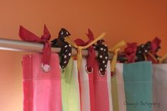 colorful curtains with bows hanging from them