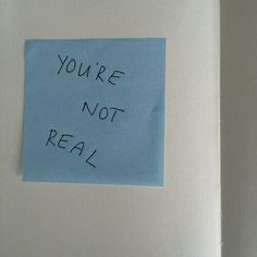 a piece of blue paper with the words you're not real written on it