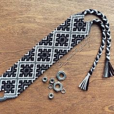 a close up of a tie on a table with beads and other items around it