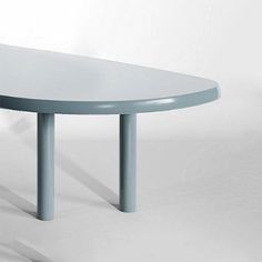 a white table sitting on top of a white floor