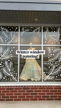 a window that has a dress in it with the words winter window painting on it