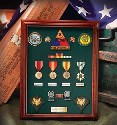 a framed shadow box with medals and ribbons