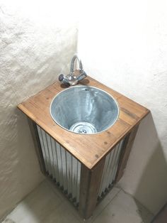 a wooden sink in the corner of a room