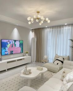 a living room filled with white furniture and a flat screen tv mounted on the wall