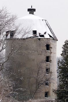 an old building with snow on the roof