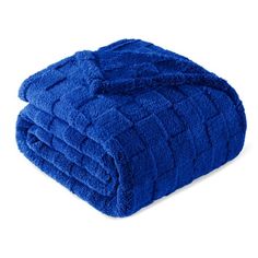 two blue towels stacked on top of each other in front of a white background,