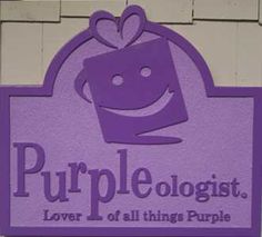 a purple sign that says purpleologists over all things purple with a smiling face on it