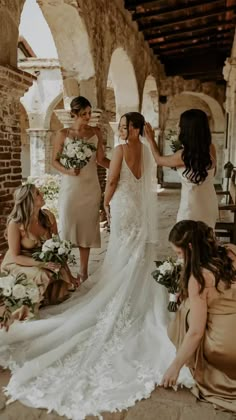 the bridesmaids are getting ready for their wedding ceremony in an old stone building