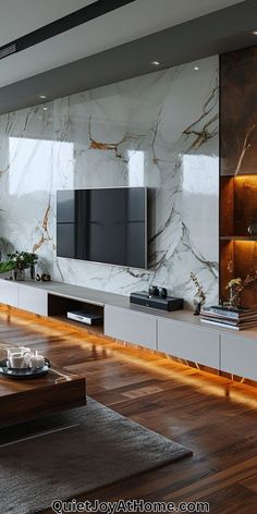 modern living room with marble wall and wooden flooring, large television on entertainment center