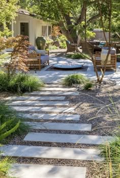 an outdoor patio with stone steps leading up to the house