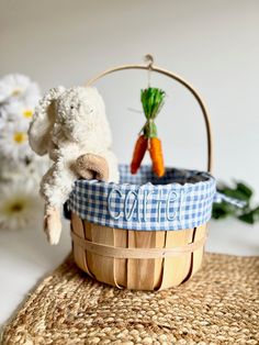 a stuffed animal is in a basket with carrots and celery on the table