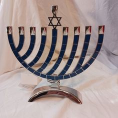 a hanukkah menorah is displayed on a white tablecloth background