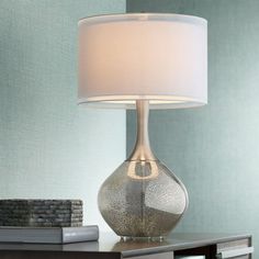 a table lamp with a white shade on it