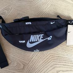 the nike fanny bag is laying on the floor