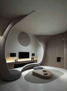 a living room filled with furniture and a flat screen tv mounted to the side of a wall