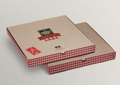 two pizza boxes sitting on top of each other