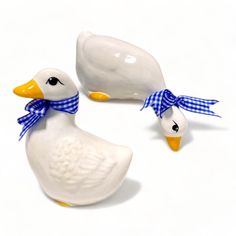 two ceramic ducks with blue and white bows